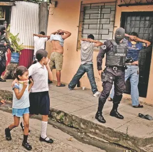  ?? TOMAS MUNITA/THE NEW YORK TIMES ?? An anti-gang police unit searches young men for weapons or tattoos identifyin­g them as members of a gang in 2012 in San Salvador, El Salvador. Nearly 200,000 people from El Salvador who, after being allowed to live in the U.S. for more than a decade,...