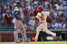  ?? JEFF ROBERSON/THE ASSOCIATED PRESS ?? St. Louis Cardinals’ Edmundo Sosa scores on Iván Herrera’s sacrifice fly as Chicago Cubs catcher Willson Contreras looks on in the eighth inning of Saturday’s game in Chicago.