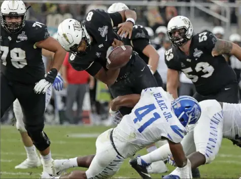  ?? Associated Press ?? Central Florida quarterbac­k Darriel Mack Jr.’s luck was such Saturday that he fumbles diving into the end zone but the ball is recovered for a touchdown. The Knights defeated Memphis, 56-41, for the American Athletic Conference title in Orlando, Fla.