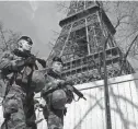  ?? BENOIT TESSIER/REUTERS ?? French soldiers patrol at the Eiffel Tower on Monday in Paris. France raised its terror alert to its highest level following Friday’s shooting in Moscow.