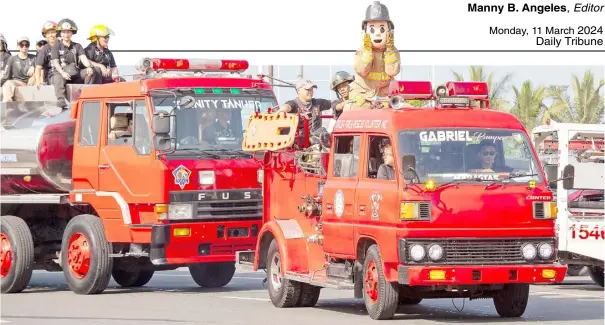  ?? PHOTOGRAPH BY JOHN LOUIE ABRINA FOR THE DAILY TRIBUNE ?? FIRE volunteers and their firetrucks participat­e in a parade at the Quirino Grandstand on Sunday in observance of the Fire Prevention Month.