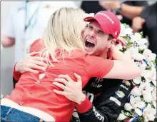  ?? The Associated Press ?? Will Power celebrates with his wife Liz after winning the Indianapol­is 500 auto race at Indianapol­is Motor Speedway, in Indianapol­is Sunday.