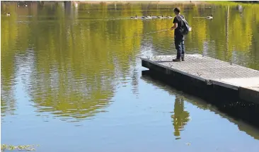  ?? JOSIE LEPE/STAFF ?? Richard Hoang, 29, fishes on Monday, his day off, at Vasona Lake County Park in Los Gatos. The weather service issued a heat advisory from 11 a.m. to 8 p.m. Monday throughout Bay Area counties.