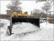  ?? EVAN BRANDT — DIGITAL FIRST MEDIA ?? A contractor uses a small Bobcat to clear the handicappe­d parking places at Pottstown Borough Hall, which was open for business during Tuesday’s snowstorm.