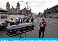  ??  ?? MEXICO CITY: A coffin is seen during a protest against alleged human rights violations committed against COVID-19 patients in the state of Nuevo Leon, in front of the National Palace in Mexico City during the novel coronaviru­s pandemic. — AFP