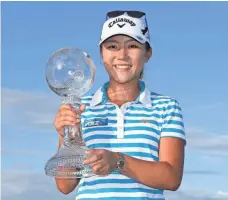  ?? SAM GREENWOOD, GETTY IMAGES ?? Lydia Ko holds the Race to the CME Globe trophy Sunday.