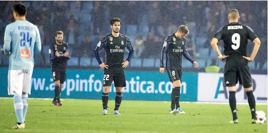  ?? — AP ?? Real Madrid players react after a goal scored by Celta Vigo during their Copa del Rey quarterfin­al second leg football match at the Balaidos stadium in Vigo, Spain, on Wednesday. Madrid drew the game 2-2 but lost the tie 3-4 on aggregate.