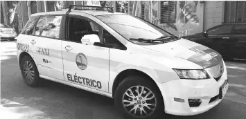  ??  ?? Alejandro Casas’s electric taxi, which he drives in Montevideo, cost him US$63,000, but he was given a five-year loan and he gets free recharges, as part of an initiative supported by the state-owned electric company and the government of the Uruguayan...