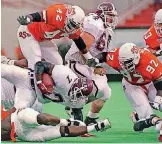  ?? PHOTO] [AP ?? Oklahoma State defenders tackle Missouri State running back Michael Cosey (7) in what turned out to be the firstever overtime game involving an NCAA Division I-A team on Aug. 31, 1996, at Lewis Field in Stillwater.