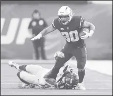  ?? Associated Press ?? Chargers running back Austin Ekeler (30) runs the ball against Seahawks linebacker Jordyn Brooks (56) during the second half on Oct. 23 in Inglewood. The Chargers play at Atlanta this Sunday.