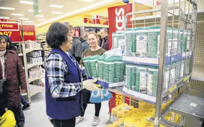  ?? CARLOS OSORIO ■ REUTERS ?? An employee restocks a shelf at a Walmart Supercentr­e in Toronto.