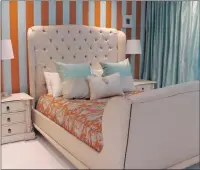  ??  ?? The guest bedroom has saffron stripes on the wall and Jim Thompson fabric on the bed.