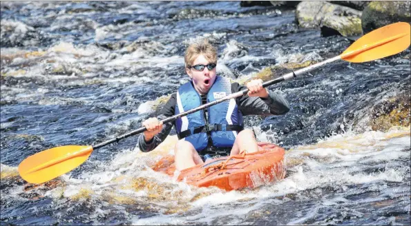  ?? KATHY JOHNSON ?? Derek McCarthy rides the rapids down Chrissy’s Falls during the annual Barrington River Run on May 12.