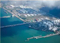  ?? (Aly Song/Reuters) ?? OIL AND GAS tanks at an oil warehouse at a port in Zhuhai, China.