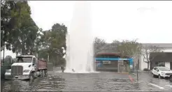  ?? ONSCENETV ?? A truck sheared off the top of a fire hydrant in a parking lot of a Hillcrest shopping center early Tuesday, sending a geyser into the air.