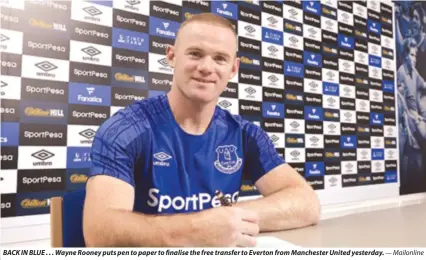 ?? Mailonline ?? BACK IN BLUE . . . Wayne Rooney puts pen to paper to finalise the free transfer to Everton from Manchester United yesterday.