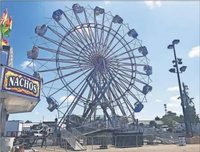  ?? [STEPHA POULIN/DISPATCH] ?? Kissel’s Military Base, a 70-foot-tall amusement ride where 16 cars can spin upside down, is blocked off at the Ohio State Fair on Thursday because it failed an inspection over corrosion. It was to be dismantled and removed by Friday morning.