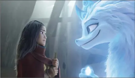  ??  ?? Raya (voiced by Kelly Marie Tran) is a young warrior princess training to become a Guardian of the Dragon Gem when she encounters Sisu (Awkwafina), a goofy young water dragon who can assume human shape in Disney’s “Raya and the Last Dragon.”