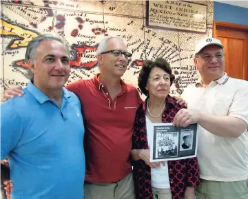  ??  ?? Inez Baker, née Schpektor, who was a Dutch refugee who lived at Gibraltar Camp in St Andrew, holds a picture of herself and other children at the camp during WWII. From left are her sons Ron and Ross, and her nephew, Jack Schpektor.