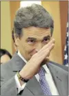  ?? MLADEN ANTONOV/ AFP/ GETTY IMAGES ?? After announcing the end of his campaign, Rick Perry salutes.