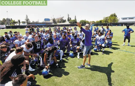  ?? Josie Lepe / Special to The Chronicle ?? San Jose State head coach Brent Brennan talks with his players. Since 2010, the Spartans are 0-13 in pay-for-play games and have been outscored 516-155.