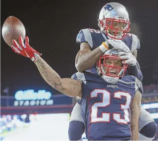  ?? STAFF PHOTO BY NANCY LANE ?? SAFETY DANCE: Patriots safeties Patrick Chung and Devin McCourty celebrate a would-be defensive touchdown that was subsequent­ly ruled an incomplete pass last night. In the end the Pats did enough to fend off Houston without it.