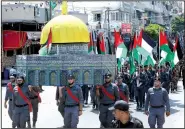  ?? AP/ADEL HANA ?? Hamas security officers carry a model of the Al-Aqsa mosque during a march Wednesday in Gaza against Israeli security measures at the contested Jerusalem shrine.