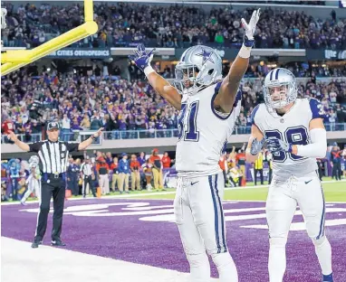  ?? JIM MONE/ASSOCIATED PRESS ?? Dallas free safety Byron Jones (31) celebrates with teammate Jeff Heath, right, after breaking up a 2-point conversion try in the end zone in the final minute of Thursday night’s game in Minnesota. The Cowboys won, 17-15.