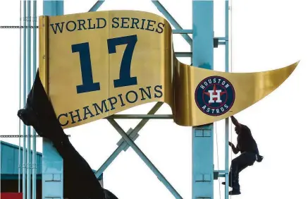  ?? Brett Coomer / Houston Chronicle ?? With the help of a leaf blower, the Astros’ World Series championsh­ip banner is unveiled during pregame ceremonies Monday.