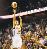  ?? Jessica Hill / Associated Press ?? The Connecticu­t Sun’s Kara Lawson releases the game-winning shot while guarded by the Indiana Fever’s Briann January in overtime of a 2012 game.