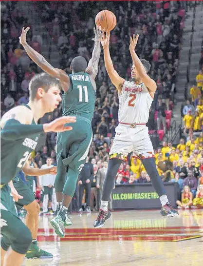  ?? JONATHAN NEWTON/THE WASHINGTON POST ?? Maryland guard Melo Trimble hits the game-winning 3-pointer over Michigan State guard Lourawls Nairn Jr. with 1.1 seconds left. The victory gives the Terps (24-7, 12-6 Big Ten) a double-bye in the conference tournament, which begins this week in...