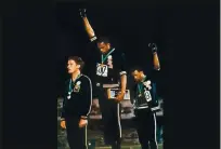  ?? ASSOCIATED PRESS ARCHIVES ?? Extending gloved hands, U.S. athletes Tommie Smith, center, and John Carlos stare downward during “The Star-Spangled Banner” at the Summer Olympic Games in Mexico City on Oct. 16, 1968.