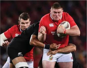  ??  ?? Tadhg Furlong is tackled by Jerome Kaino and Codie Taylor of New Zealand.