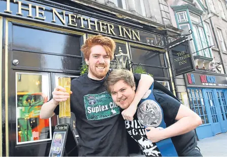  ??  ?? Nether Inn barman Graeme Robertson and duty manager Ryan Hanlon get into the grappling spirit.