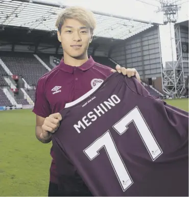  ??  ?? New Hearts loan signing Ryotaro Meshino at Tynecastle yesterday after completing his move.