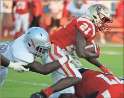  ?? Jeremy Stewart ?? Rome’s Trey Lawrence (21) works to find a way upfield during the first quarter of a scrimmage against New Manchester on Friday at Barron Stadium.