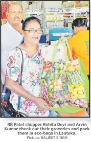  ?? Picture: BALJEET SINGH ?? RB Patel shopper Rohita Devi and Arvin Kumar check out their groceries and pack them in eco-bags in Lautoka.