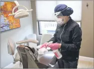  ??  ?? Caroline Christof, a Dental Tech at Berks Prosthodon­tics, cleans the examine room with disinfecta­nt between patients.