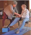  ??  ?? Yoga instructor Jamie Mullen (left) helps Charlotte Bleistein with stretches.