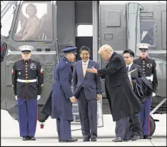  ?? SUSAN WALSH / AP ?? President Donald Trump and Japanese Prime Minister Shinzo Abe depart Marine One before boarding Air Force One on Friday. Trump is hosting Abe at Mar-a-Lago in Palm Beach, Fla.