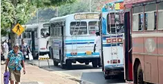  ??  ?? Several buses stop haphazardl­y along the road away from the designated bus stop. Pic by Priyantha Wickramara­chchi