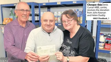  ??  ?? Cheque thisDenis Curran MBE, centre, receives the donation from John Keenan and Helen Duddy