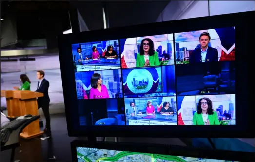  ?? HELEN H. RICHARDSON — THE DENVER POST ?? Monitors show mayoral candidates Kelly Brough, Mike Johnston and moderators during a debate in the studios of Channel 7 News on Tuesday.