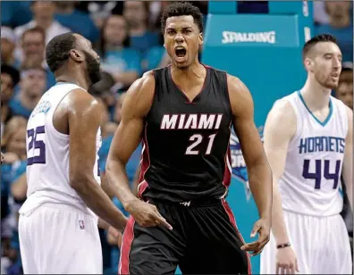  ?? AP/CHUCK BURTON ?? Miami forward Hassan Whiteside reacts after making a basket late in Friday’s NBA playoff game against Charlotte. Whiteside had 12 points, 7 rebounds and 4 blocks as the Heat beat the Hornets 97-90 to force a Game 7 in their first-round series.