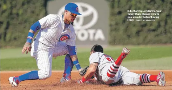  ?? | CHARLES REX ARBOGAST/ AP ?? Cubs shortstop Javy Baez tags out Tommy Pham, who was trying to steal second in the fourth inning Friday.