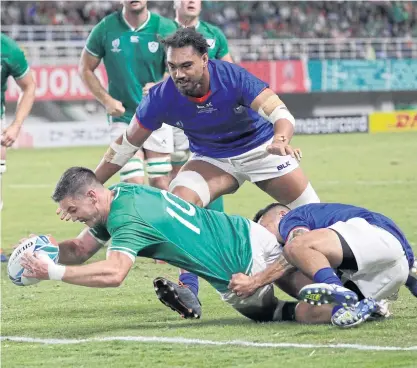  ??  ?? Ireland’s Johnny Sexton reaches out to score a try against Samoa in Fukuoka.
