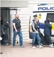  ?? JUSTIN TALLIS, AFP/ GETTY IMAGES ?? Police lead two women from a residence Sunday in Barking, east London into a police van as investigat­ions continue following Saturday’s terror attacks in central London that killed at least 7.