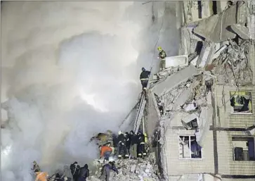  ?? Vitalii Matokha AFP/Getty Images ?? AT LEAST nine people were killed and scores wounded Saturday in a Russian missile strike that hit this apartment building in Dnipro, Ukraine. Both sides appear resolved to continue fighting over territory.