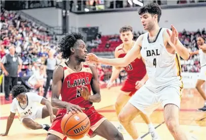  ?? U SPORTS ?? Spencer Riar of the Dalhousie Tigers defends against Laval Rouge et Or’s Steeve Joseph during a U Sports Final 8 men’s basketball semifinal played Saturday night in Quebec City.