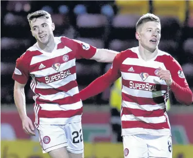  ??  ?? Pat on the back Darren Lyon congratula­tes Greg Docherty on his sensationa­l derby strike